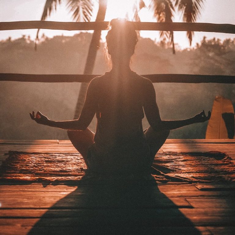 Woman meditating in a peaceful setting, practicing mindfulness and relaxation